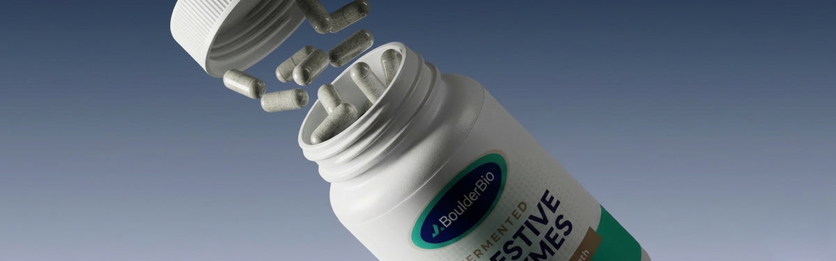 Open BoulderBio Digestive Enzymes bottle with capsules floating between the lid and container on a gradient blue background.